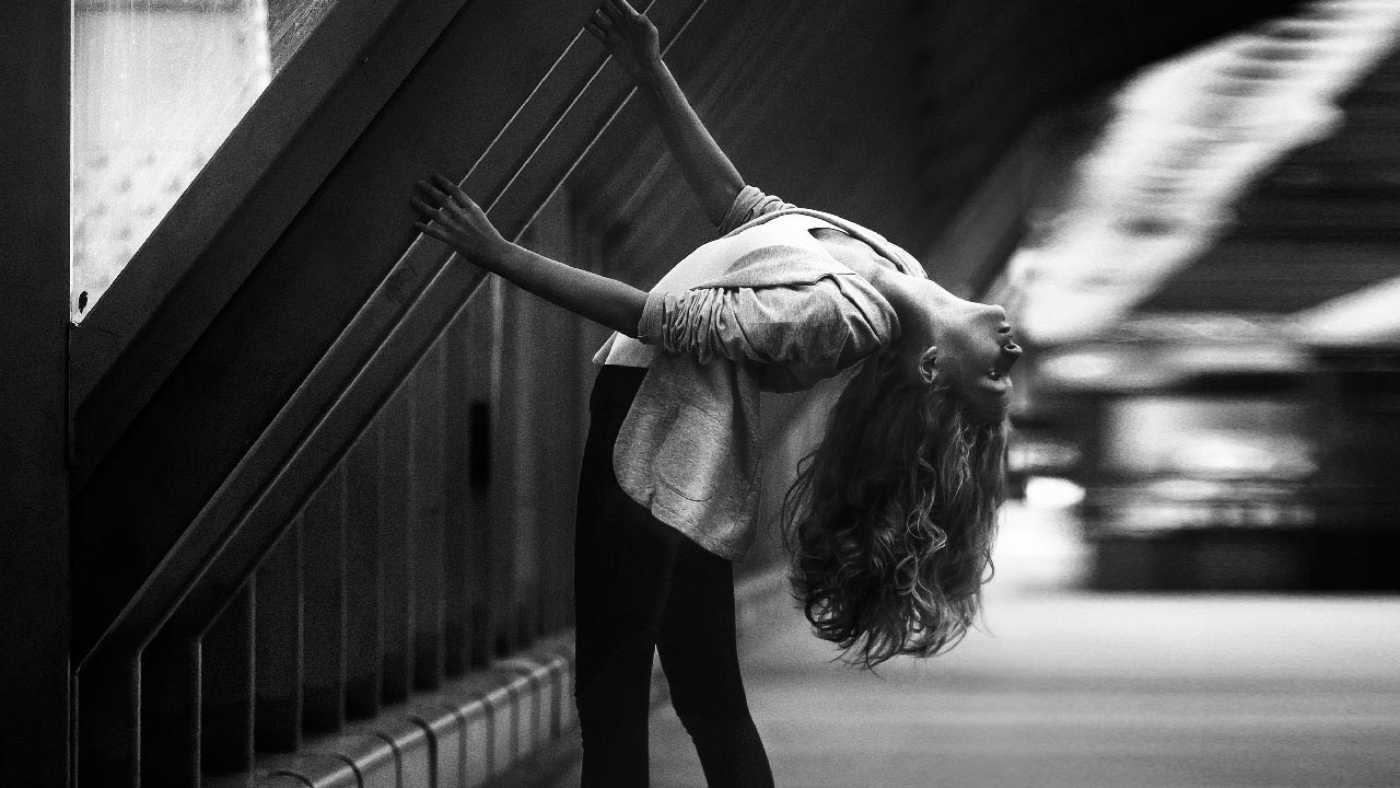 Black And White Photography. A Girl Dancing In The Street.