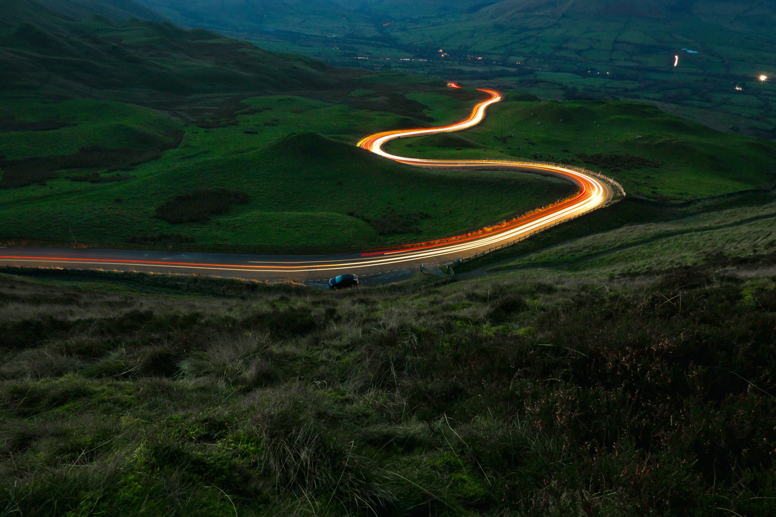 Landscape at dusk with a long exposure car light.
